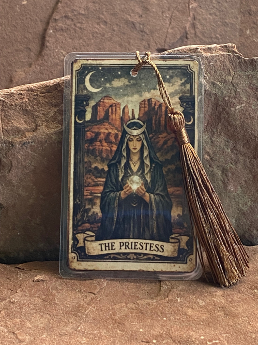 Tarot card featuring 'The Priestess' with a crystal ball on a stone surface
