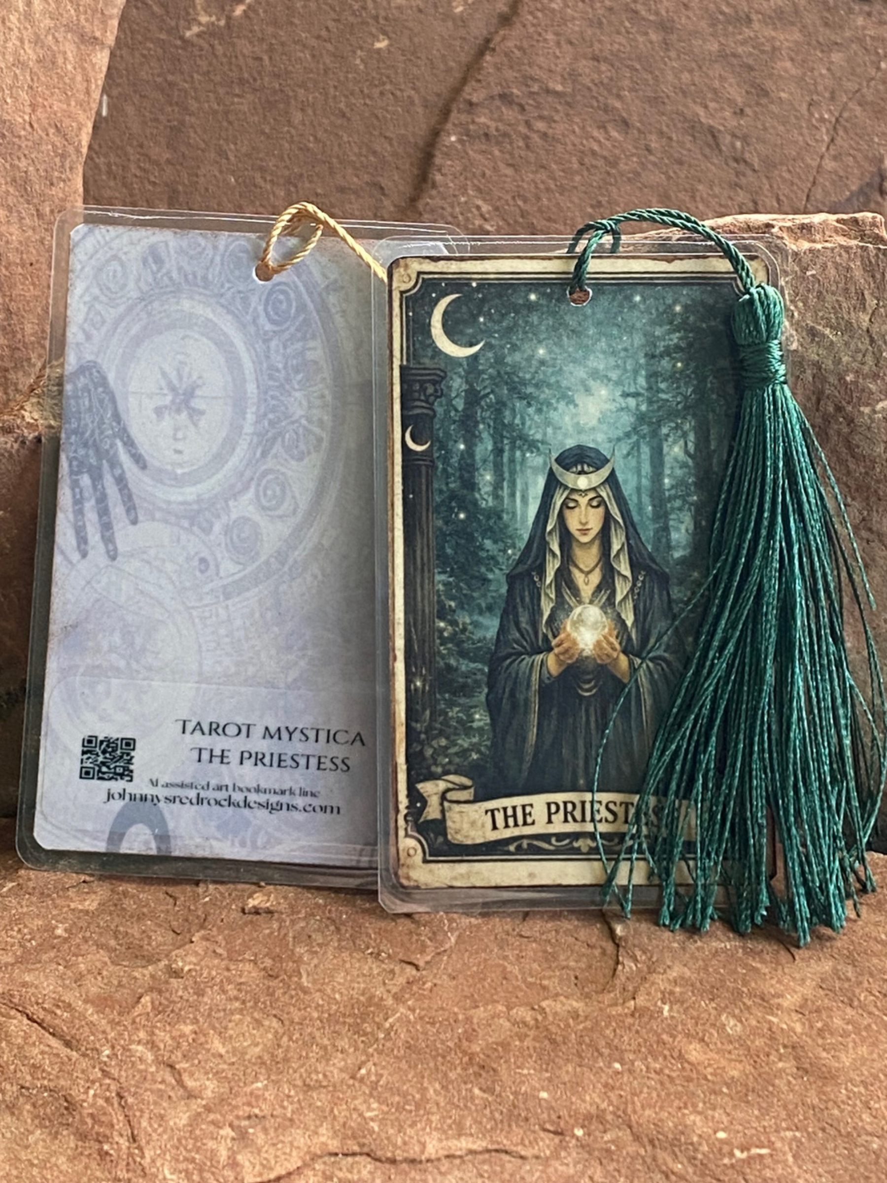 Tarot card featuring 'The Priestess' with a tassel on a stone surface.  Front and back shown