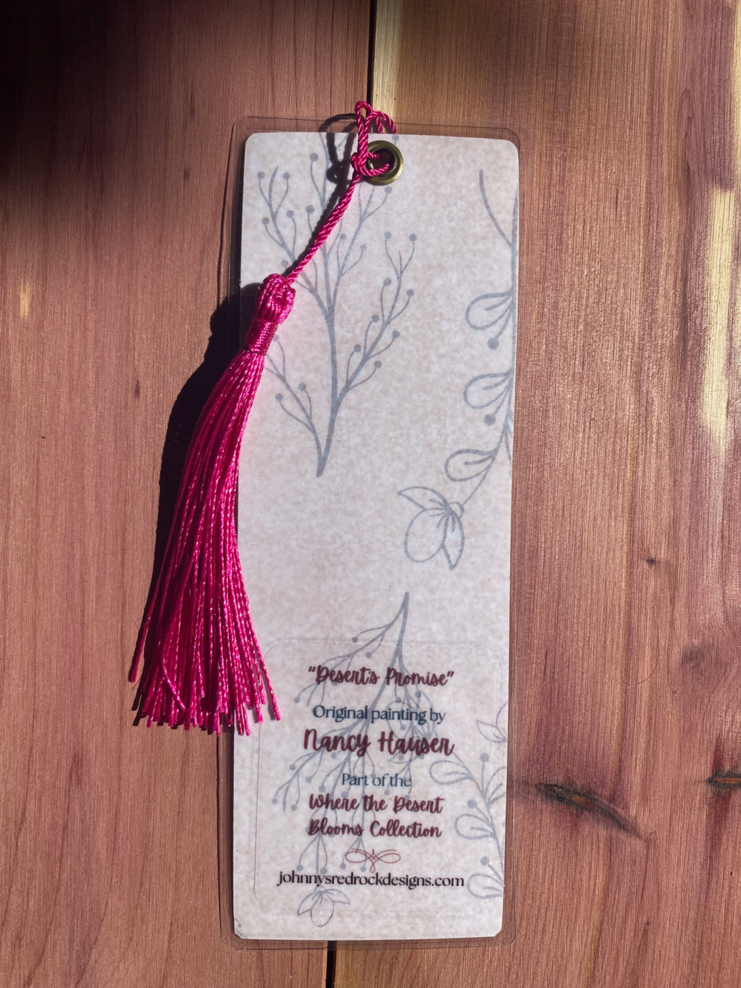 Bookmark back with tassel on a wooden surface