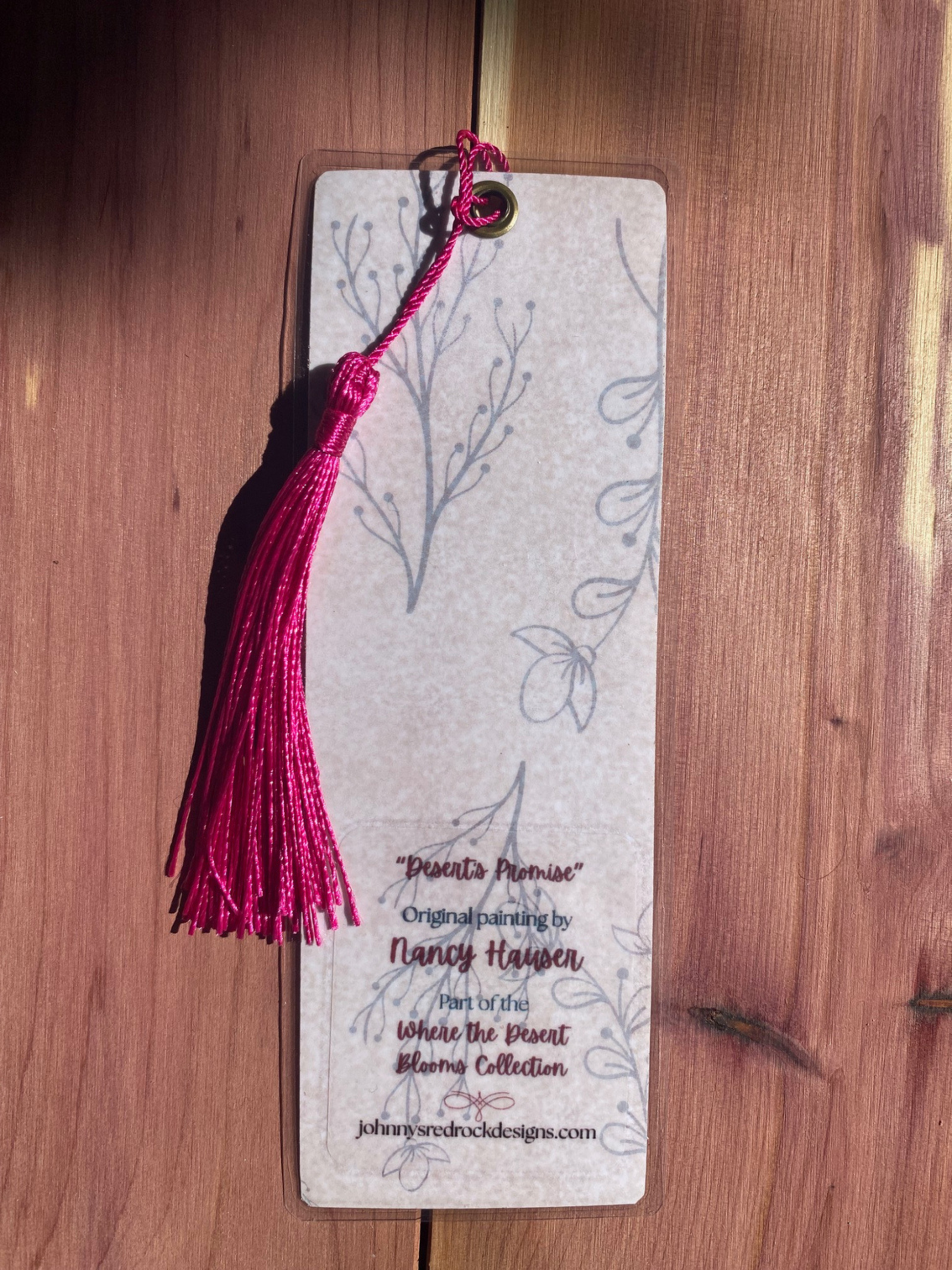 Bookmark back with tassel on a wooden surface