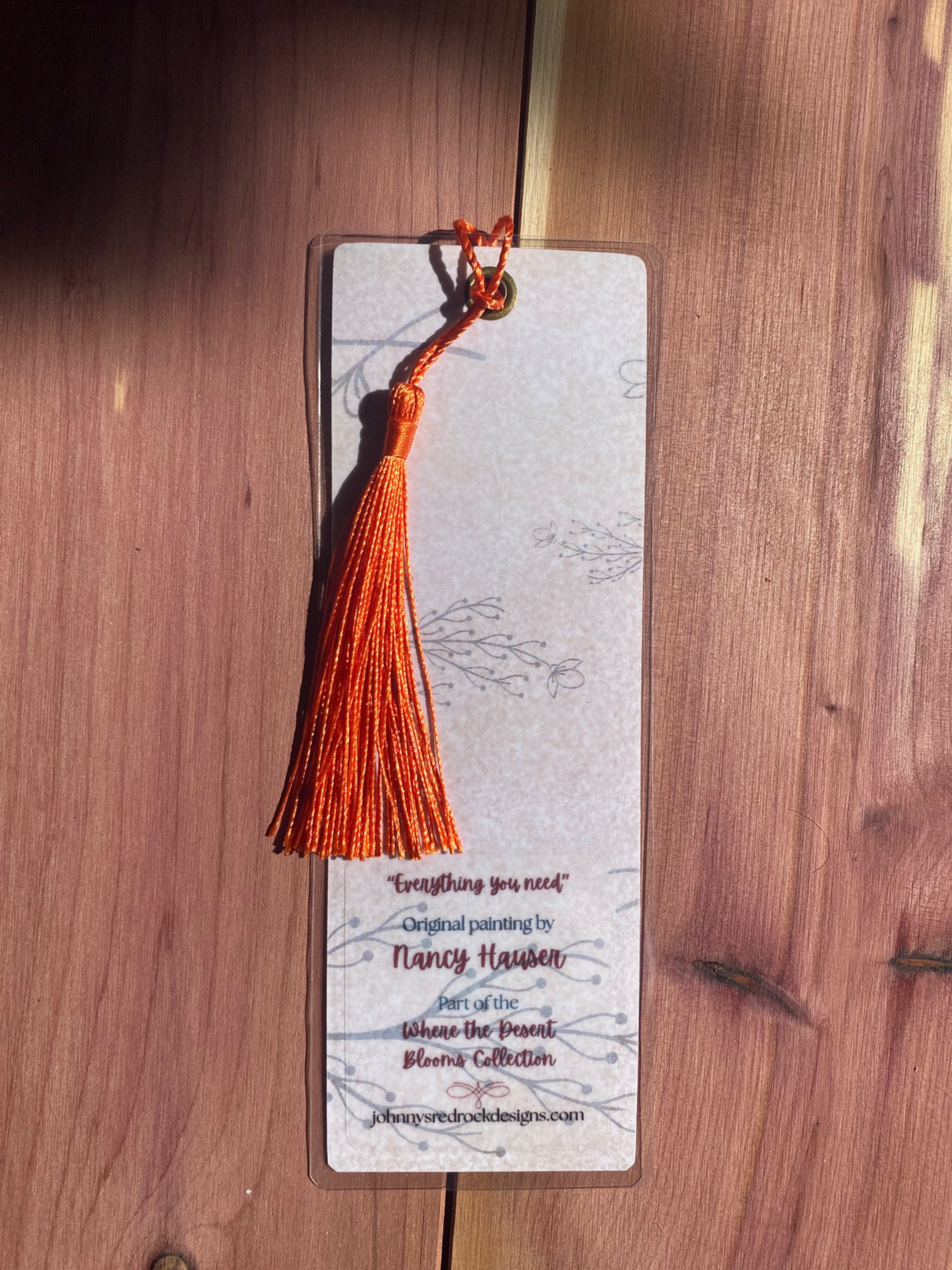 Bookmark back with tassel on a wooden surface
