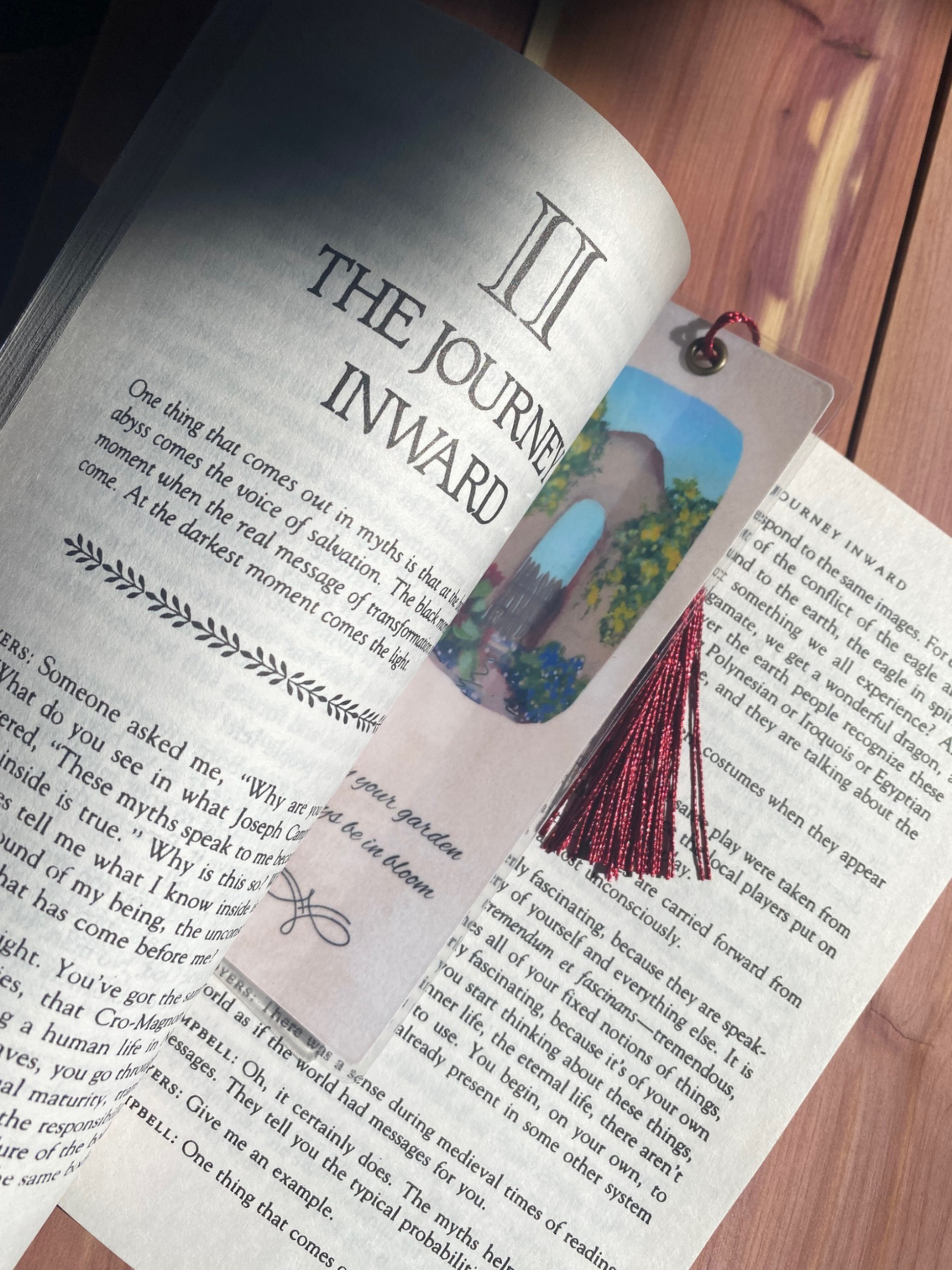 Bookmark shown in oversized paperback book for scale
