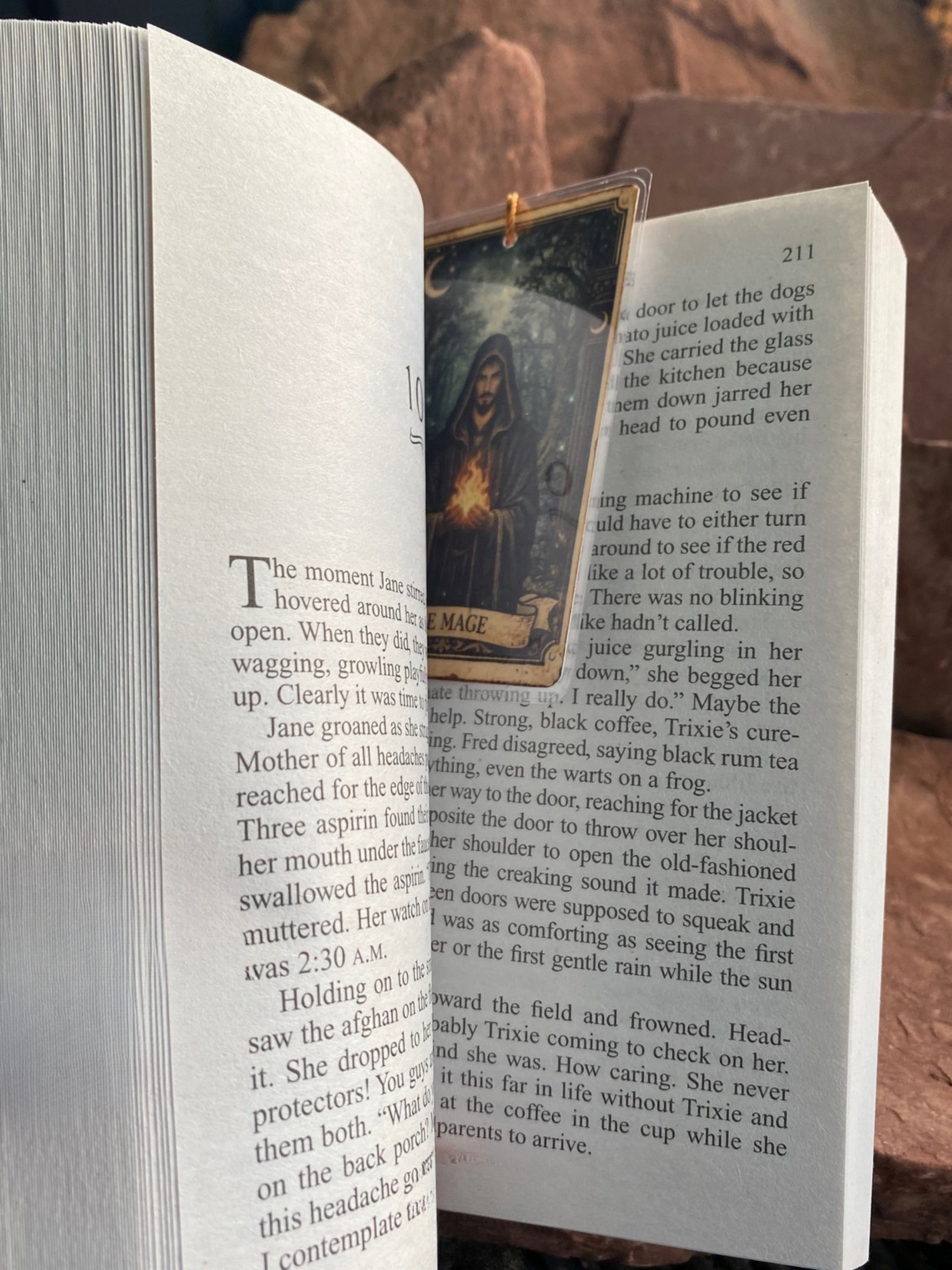 Open book with a small bookmark inserted between the pages on a brown surface