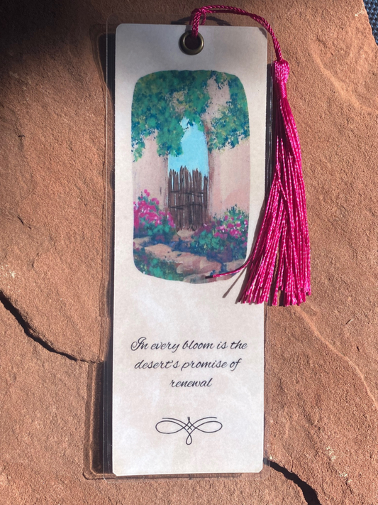 Bookmark with tassel featuring a scenic illustration and text on a textured surface