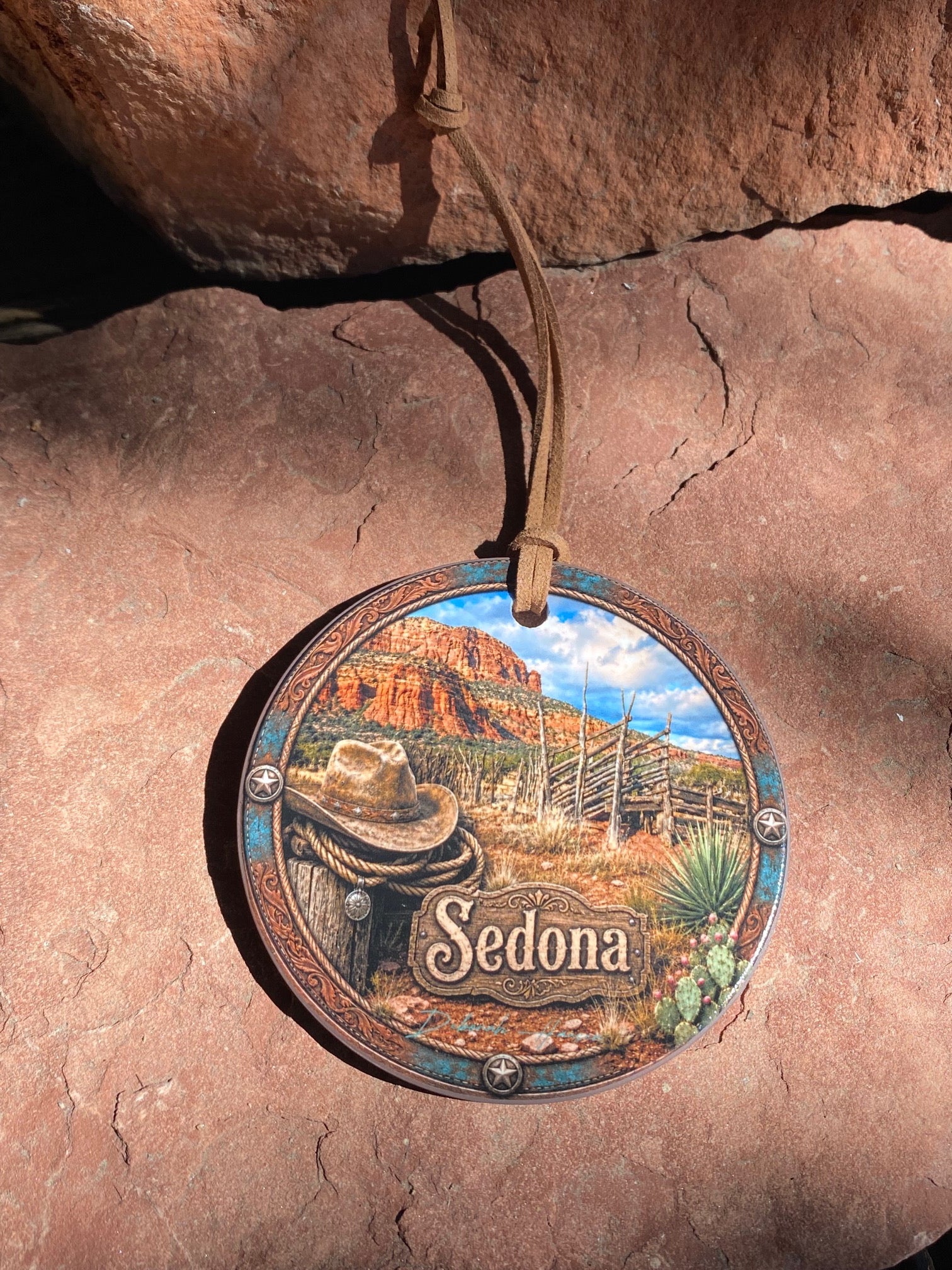 Ceramic ornament featuring old corral western hat